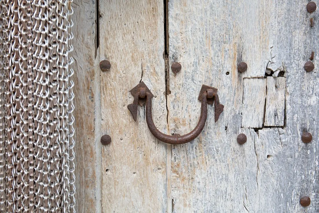 An old, weathered door studded with rusted iron