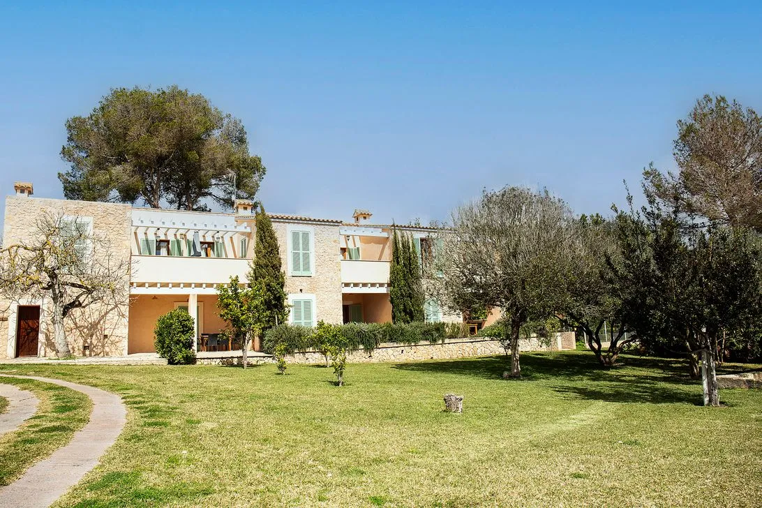 The stone building with balconies above the green lawn