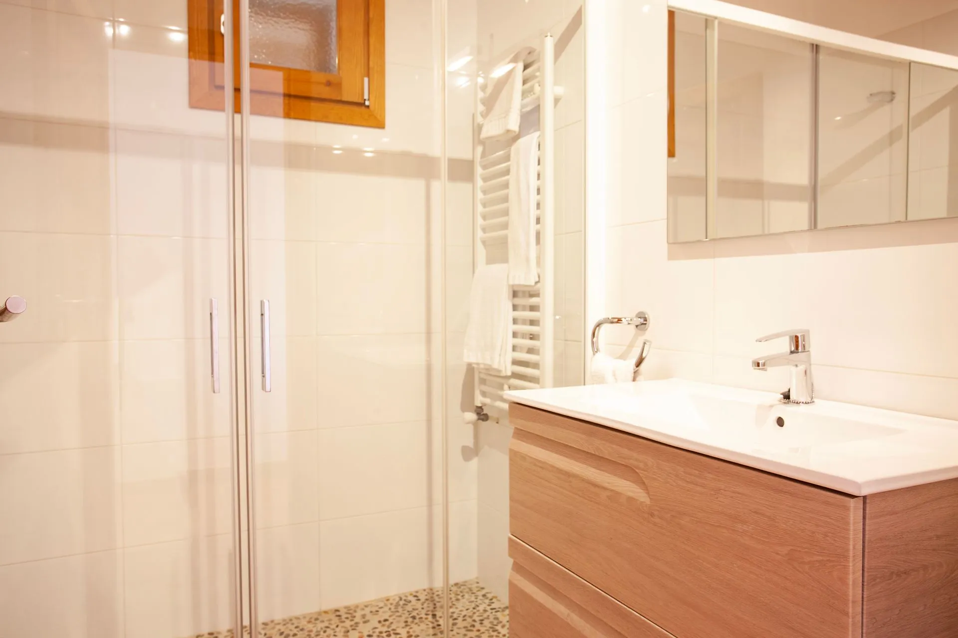 A clean bathroom with a basin and a walk-in shower