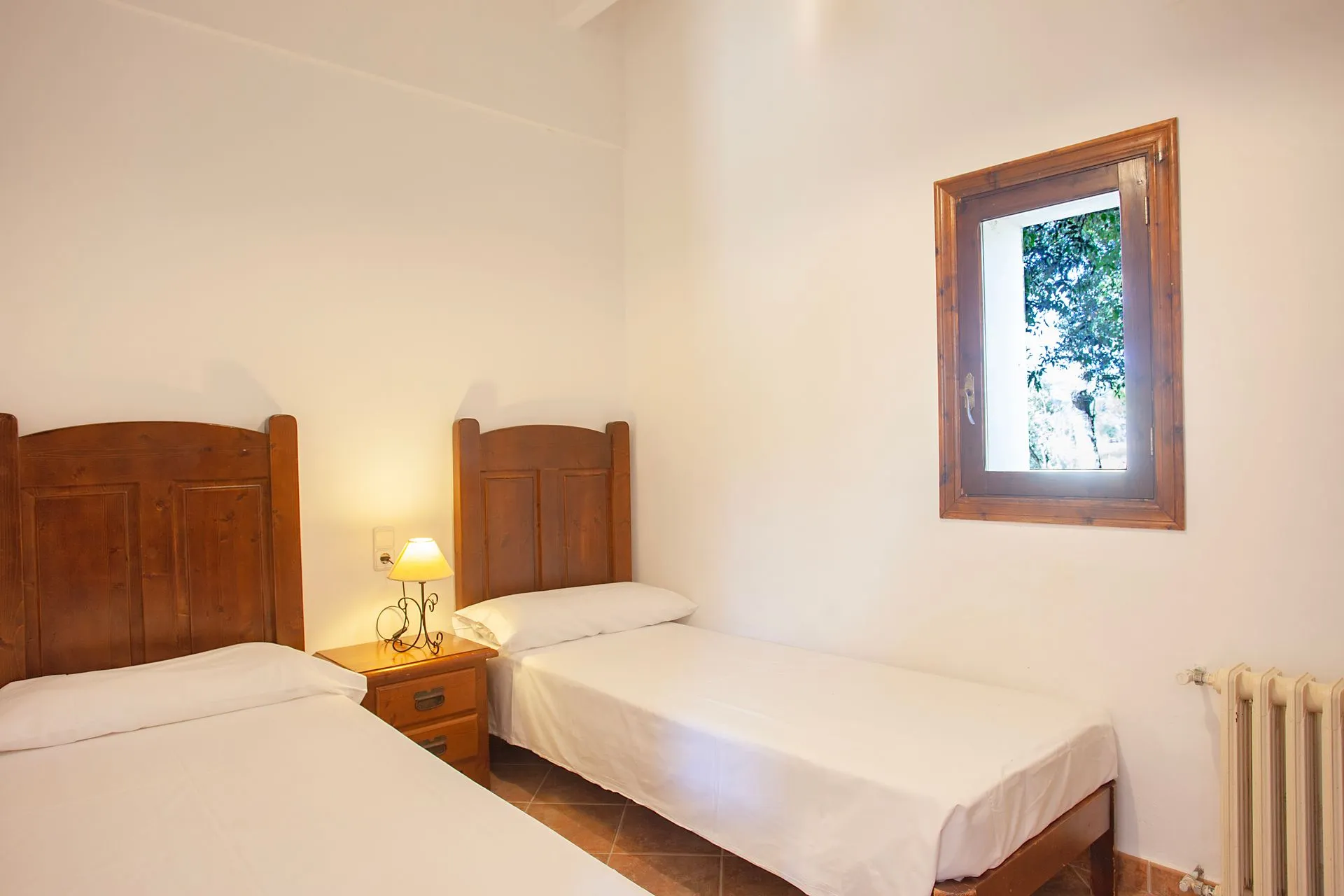 A simple twin room, two beds beneath a window